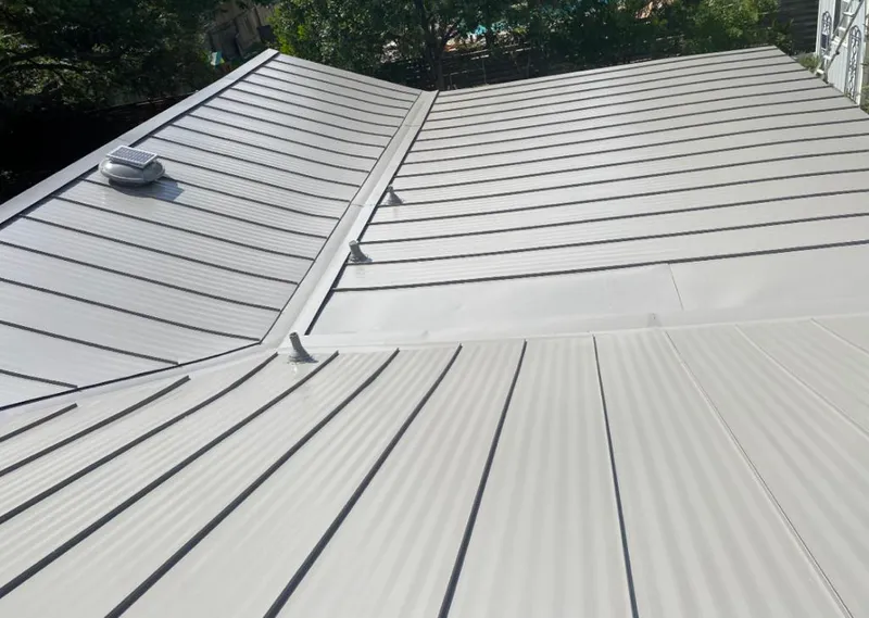 Solar attic fan installed on a metal roof for Roof Ventilation in Morgan City