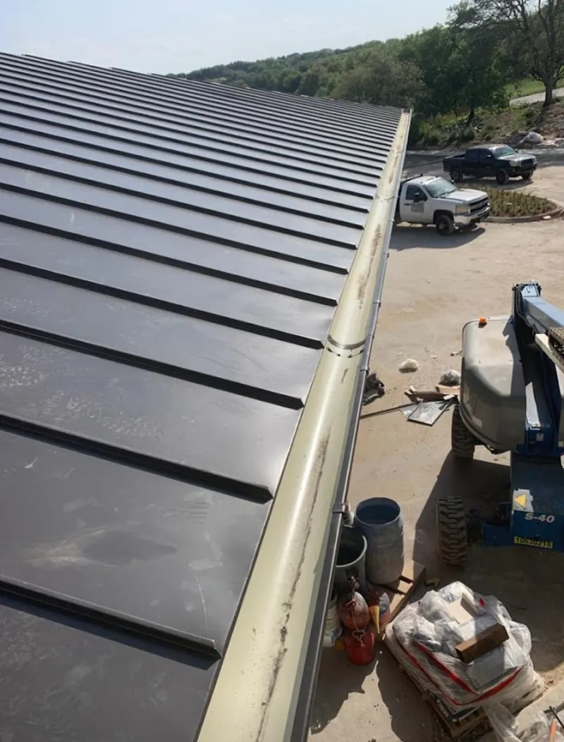 Standing seam panel and gutter detail on a metal roofing jobsite in Morgan City